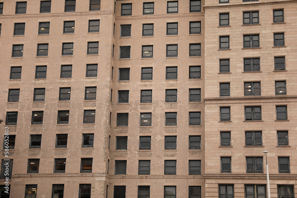 A multi-story brick building featuring a mix of commercial offices and residential apartments, with classic architectural details and large windows. A multi-story brick building featuring a mix of commercial offices and residential apartments, with classic architectural details and large windows.