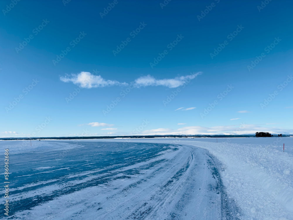 Winter landscape of a road on a frozen lake in north Sweden Winter landscape of a road on a frozen lake in north Sweden