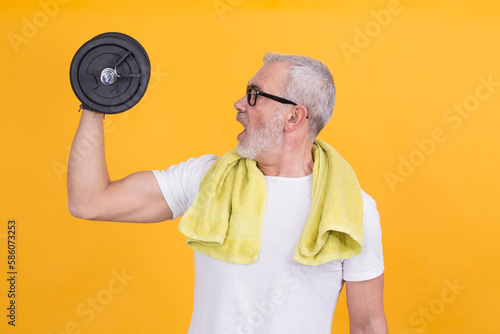 mature man exercising with dumbbells