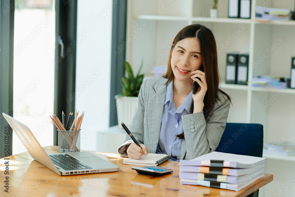 business woman have the joy of talking on the smartphone, tablet and laptopon the modern office business woman have the joy of talking on the smartphone, tablet and laptopon the modern office