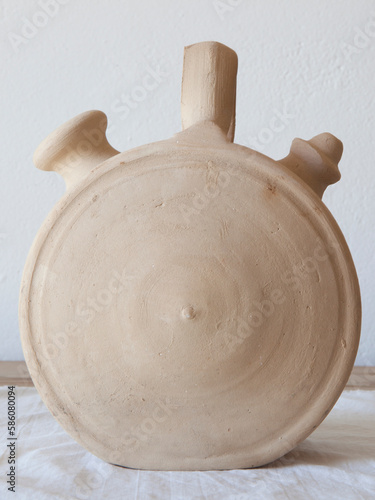 White earthenware botijo, traditional clay pot jug photo