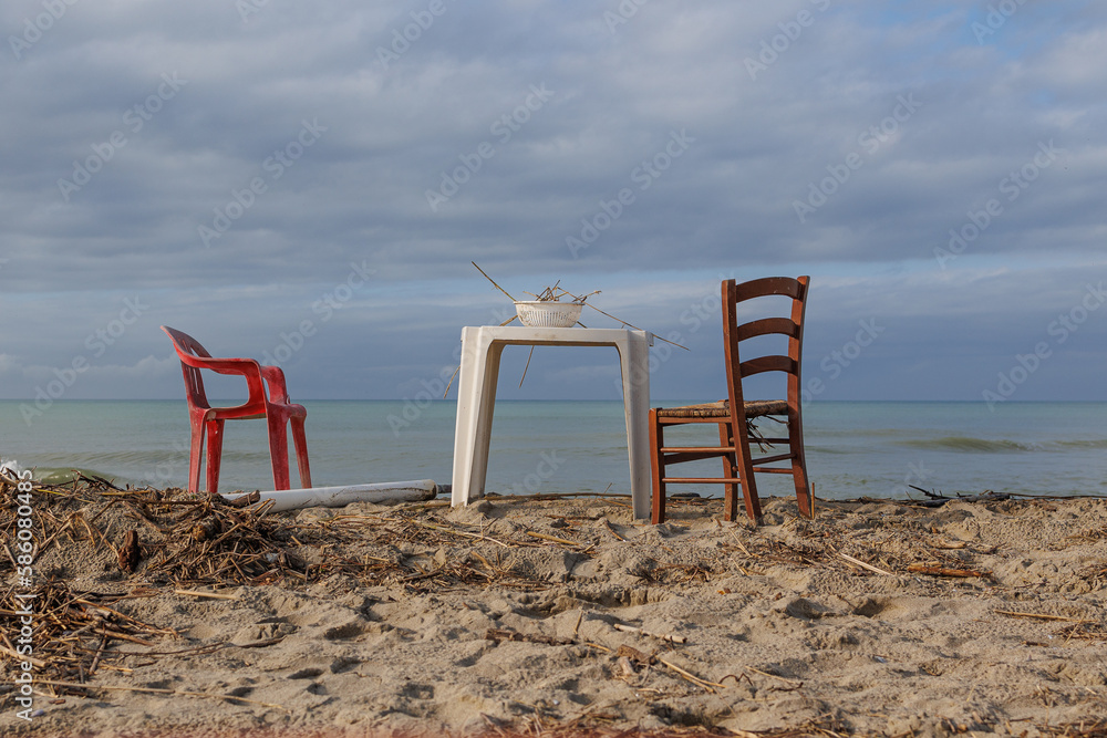 Two Chairs and a Plastic Side Table with a Colander Resting on top with Wood Remains Two Chairs and a Plastic Side Table with a Colander Resting on top with Wood Remains