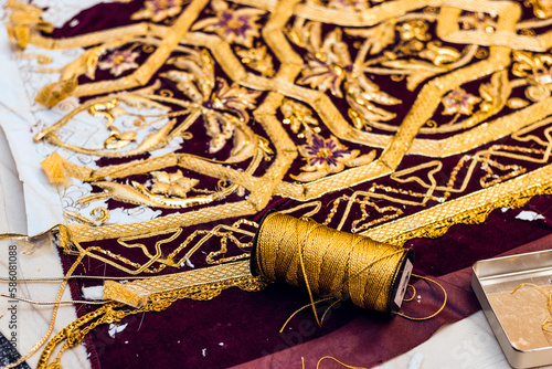 Holy Week textile manufacturing. Close-up of a spool of gold thread for Easter costumes.