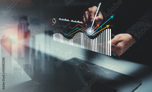 Businessman analyzing company growth, future business growth arrow graph, development to achieve goals, business outlook, financial data for long term investment.
