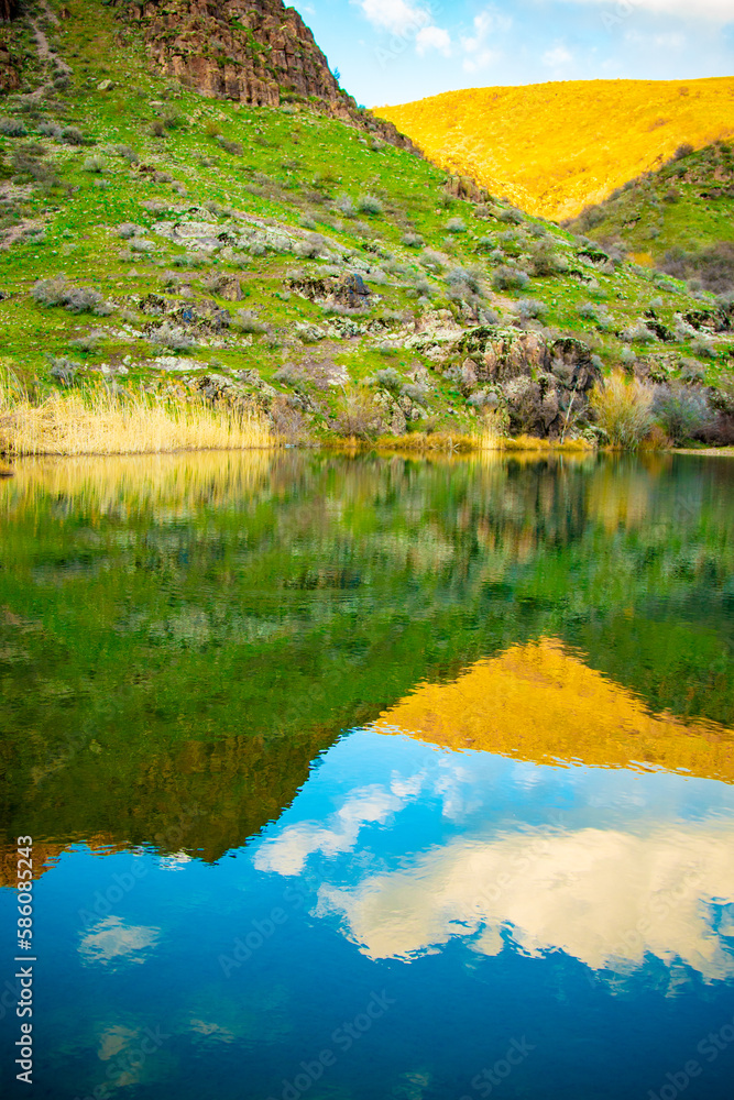 Beautiful alpine lake with reflections of beautiful clouds in the water Beautiful alpine lake with reflections of beautiful clouds in the water