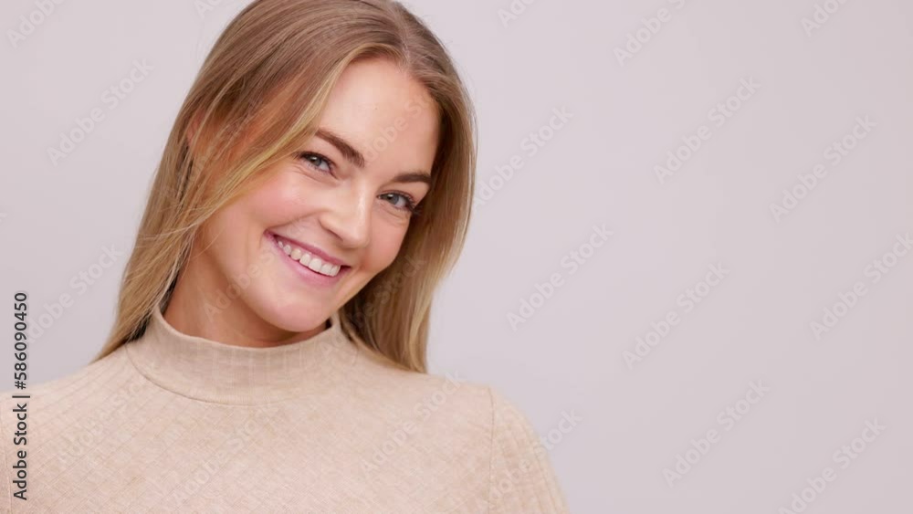 Video closeup of young blonde caucasian woman on white background smiling, looking down and tilting her head, naturally and beautiful female girl. Video closeup of young blonde caucasian woman on white background smiling, looking down and tilting her head, naturally and beautiful female girl.