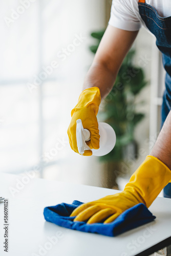 people doing cleaning are using cloths and spraying disinfectant Wipe the desk and floor in the office room..cleaning staff.cleaning maid