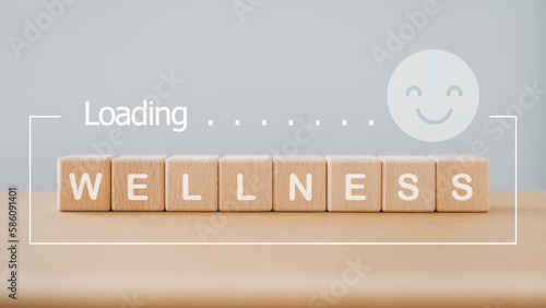 For wellness, wellbeing, relaxation mental health concept. wellness word on wooden cube block with loading and smiling face