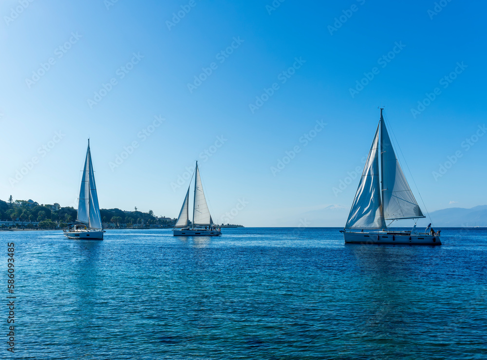 Naklejka premium boats and yachts at the sailing regatta on open water. Sailing on the wind waves in the sea.