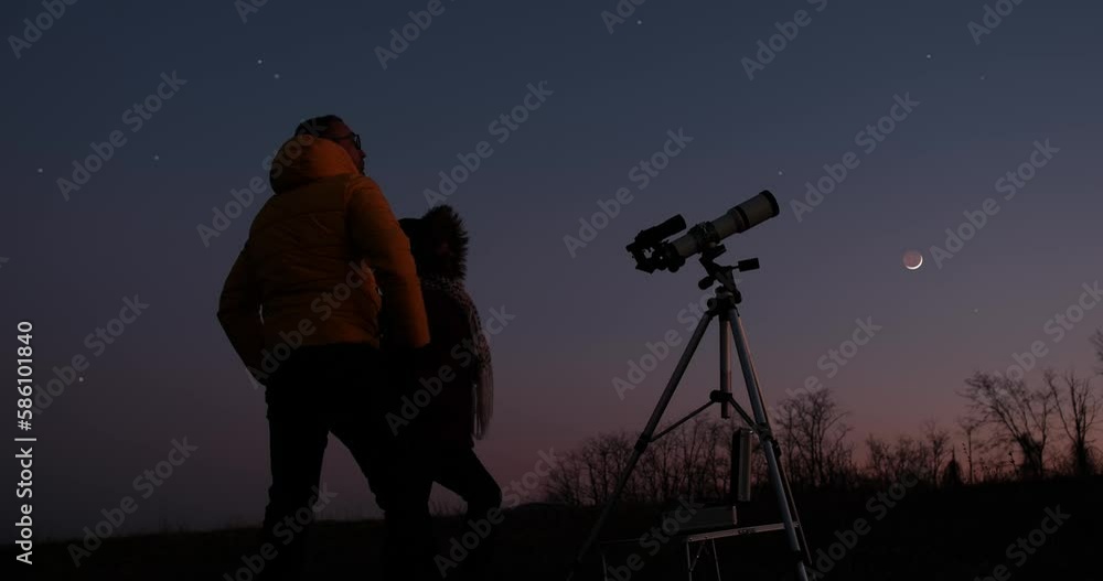 Couple looking at the stars and Moon with astronomy telescope on the countryside. Couple looking at the stars and Moon with astronomy telescope on the countryside.