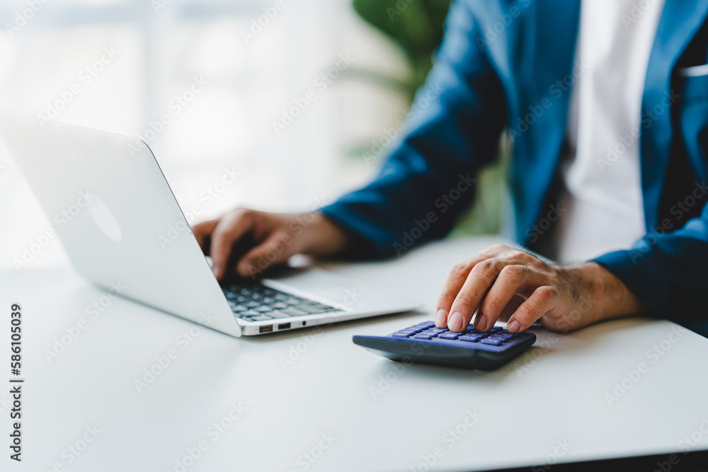 Close-up of business people working on taxes, financial accounting calculations, brokerage, copy space Close-up of business people working on taxes, financial accounting calculations, brokerage, copy space
