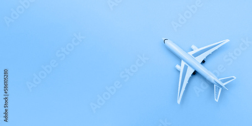 Model plane on blue color background. Miniature airplane. Copy space. Banner.