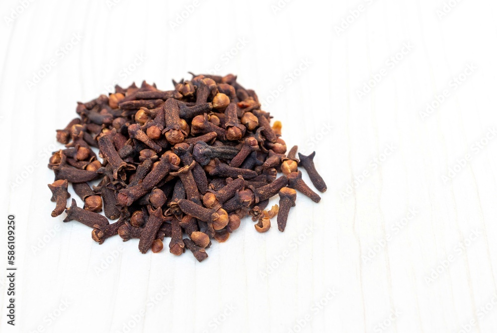 Dry Clove Spice Isolated on White Wooden Background with Copy Space