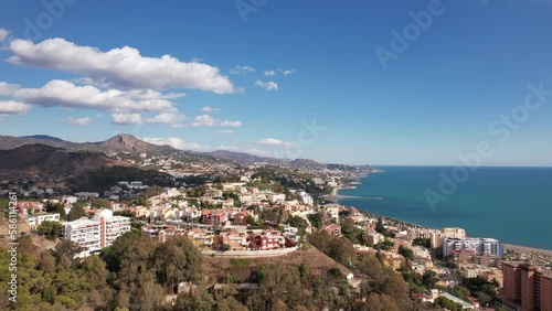 Beautiful coastal town of Malaga spain on sunny day with white fluffy clouds photo