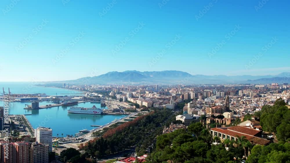 Gentle rising aerial tilt overview of Malaga spain coastal city and mountains Gentle rising aerial tilt overview of Malaga spain coastal city and mountains