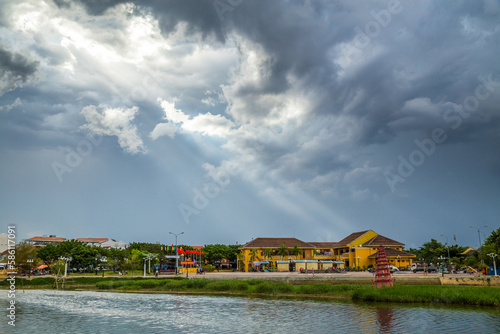 Shafts of light breaking through clouds of historic buildings at Hoi An in Vietnam