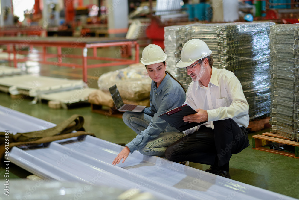 partner woman engineer assistant in helmet inspection check heavy machine construction installation in industrial metal roof roll sheet factory with colleague manager. partnership operation factory partner woman engineer assistant in helmet inspection check heavy machine construction installation in industrial metal roof roll sheet factory with colleague manager. partnership operation factory