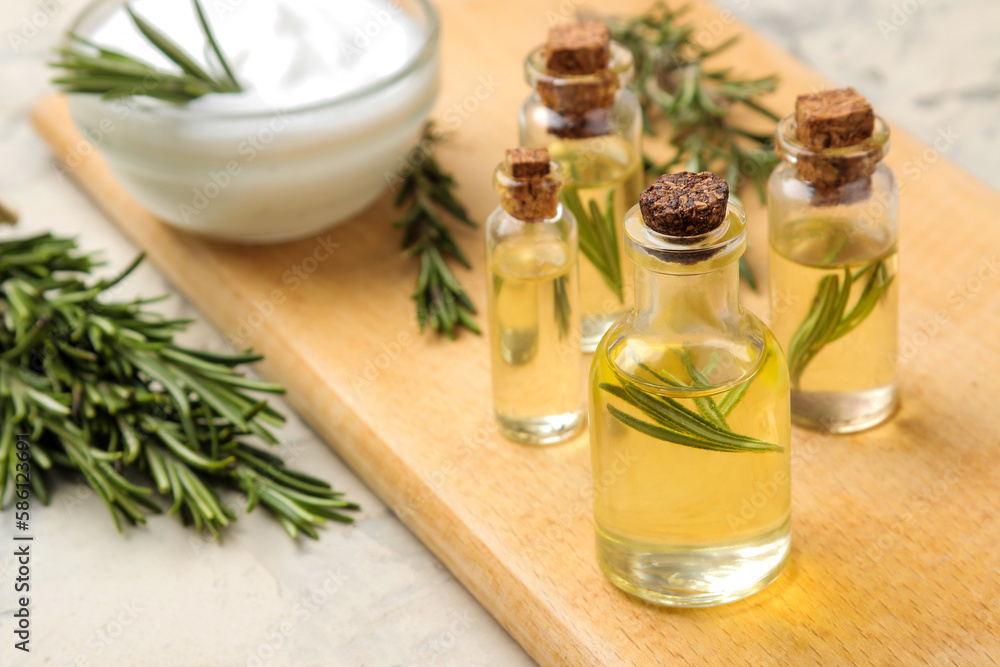 Rosemary essential oil and cream on a light background. face and body skin care. spa. Rosemary essential oil and cream on a light background. face and body skin care. spa.