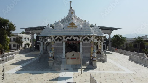 Unhel, Rajasthan, India 12th March 2023: 4k Drone shots of Shri Nageshwar Parshwanath Tirth or Shri Jain Shwetamber Nageshwar Parshwanath Tirth Pedhi is a Jain Temple. Standing Jain Murti or Idol. photo