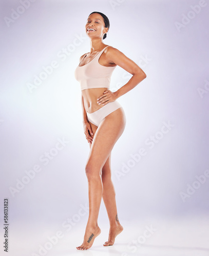 Portrait, proud and underwear with a model woman in studio on a gray background to promote skincare. Body, wellness and natural with an attractive young female posing in lingerie for hair removal