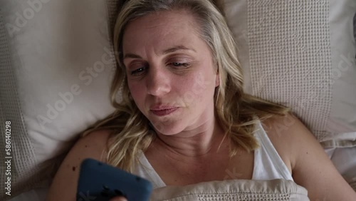 Menopausal Mature Woman Suffering With Insomnia In Bed At Home 