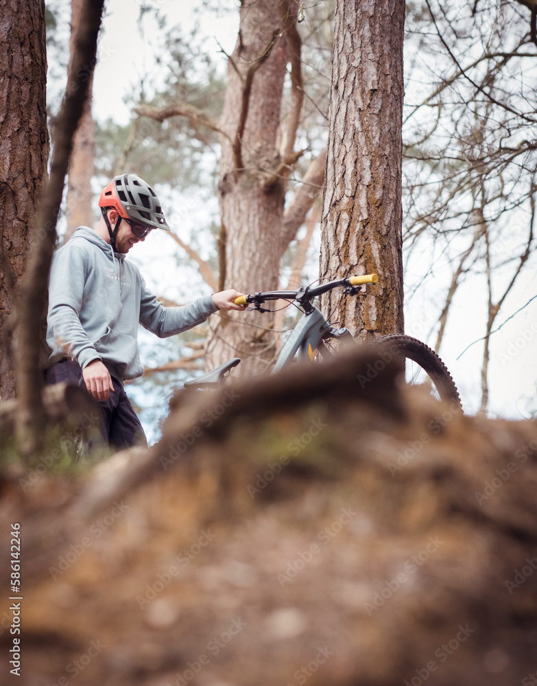 Mountain biker jumping in the forest