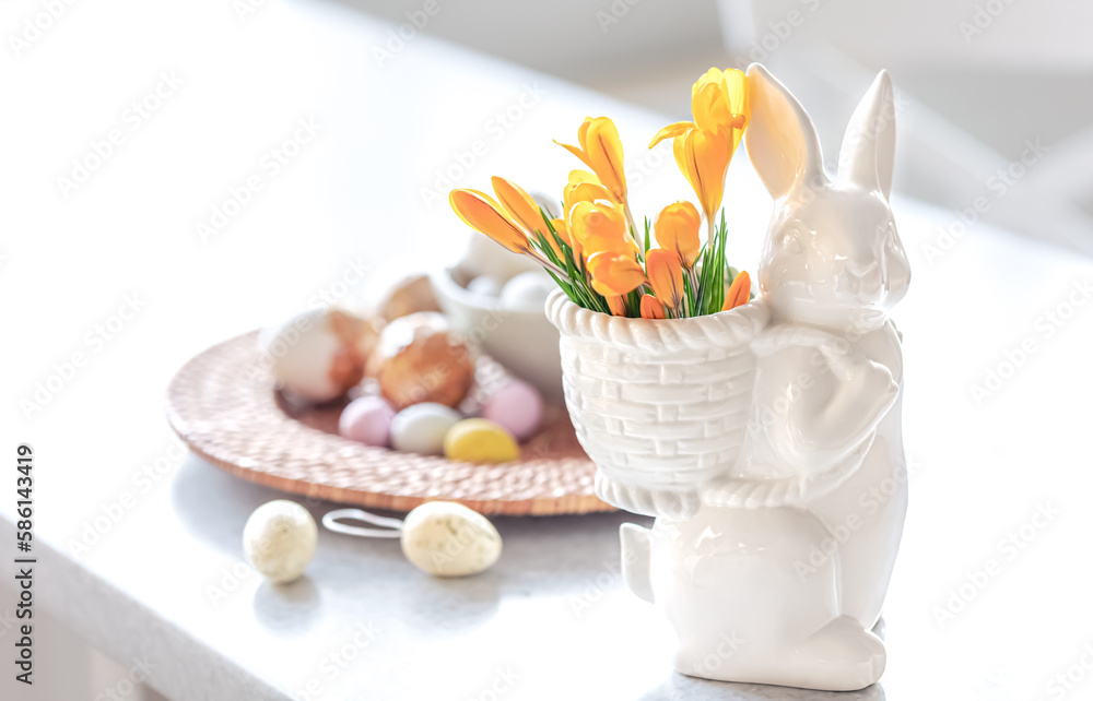 Easter still life with a ceramic hare, eggs and flowers.