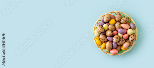 Color sweet candy on blue background, easter concept © Denira