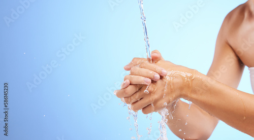 Water, girl or washing hands in studio on blue background for wellness or skincare hydration. Healthcare mockup, body care zoom or woman cleaning with liquid splash for hygiene or bacteria prevention