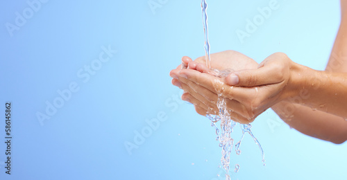 Water splash, woman or cleaning hands in studio on blue background for wellness or skincare hydration. Mockup space banner, palm or girl with liquid splash hand wash in hygiene or bacteria prevention