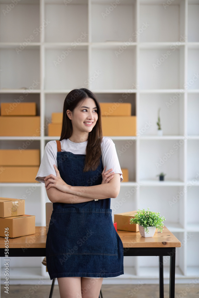 Starting Small business entrepreneur SME freelance, Portrait young woman working at home office, BOX, smartphone, laptop, online, marketing, packaging, delivery, b2b, SME, e-commerce concept.. Starting Small business entrepreneur SME freelance, Portrait young woman working at home office, BOX, smartphone, laptop, online, marketing, packaging, delivery, b2b, SME, e-commerce concept..