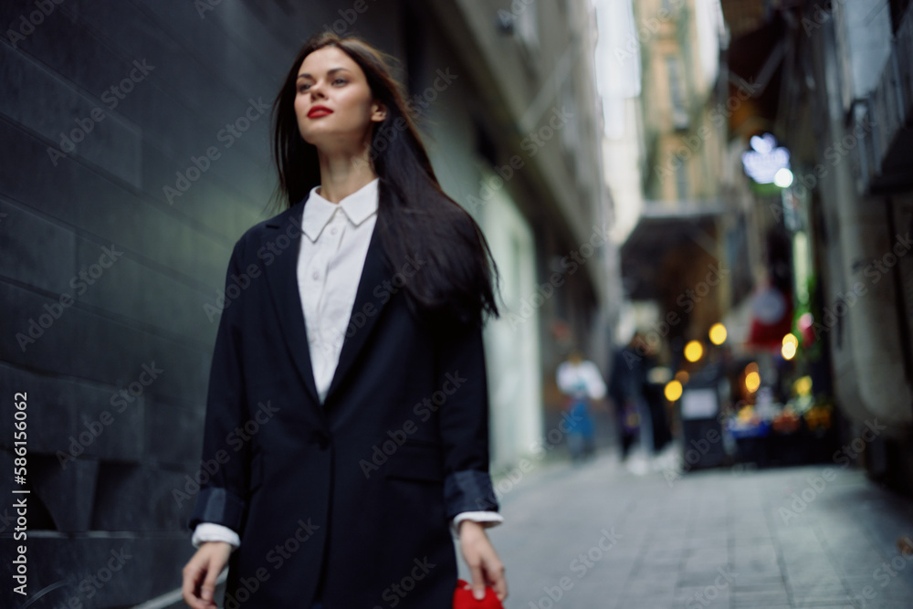 Fashion woman tourist in stylish clothes in a jacket and red beret walking down a narrow city street flying hair and happy travel, French style, cinematic color, retro style. Fashion woman tourist in stylish clothes in a jacket and red beret walking down a narrow city street flying hair and happy travel, French style, cinematic color, retro style.