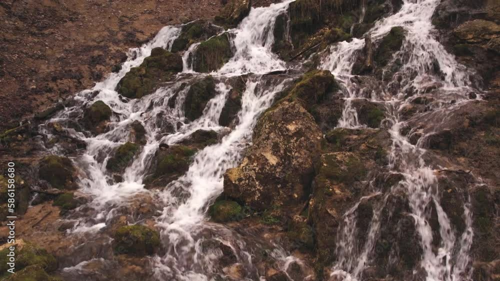 Dolomite waterfall in the forest. Nature trail to waterfall spring Dolomite waterfall in the forest. Nature trail to waterfall spring