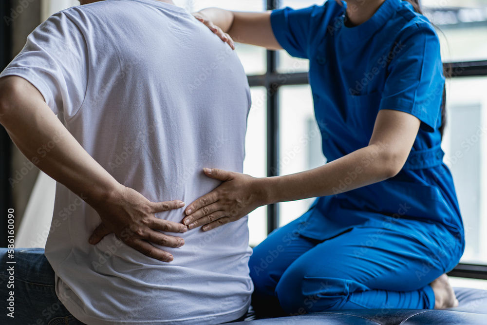 Young Asian man doing physiotherapy and seeking advice from muscle pain with shoulder, limbs in rehabilitation center. Young Asian man doing physiotherapy and seeking advice from muscle pain with shoulder, limbs in rehabilitation center.