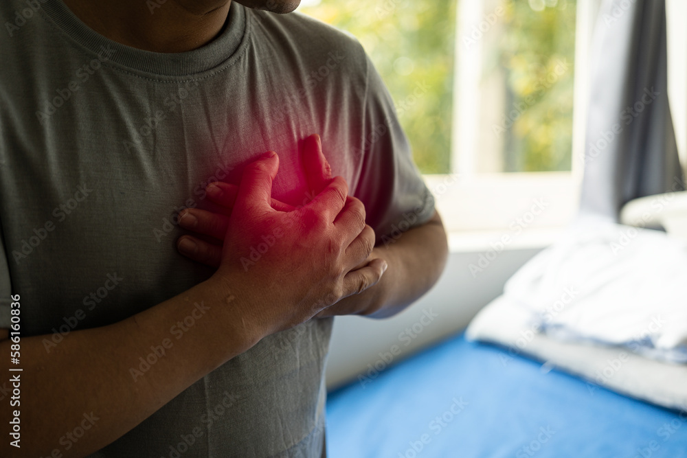 Foto de Chest pain, young asian man having a heart attack, man