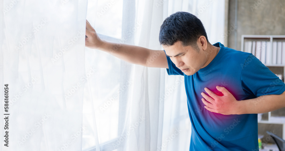 Chest pain, young asian man having a heart attack, man suffering from