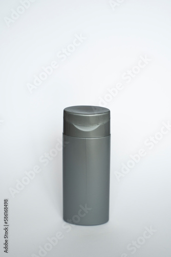 Black shampoo packaging mockup. Vertical empty plastic cosmetic package for man, isolated on white background. Container of conditioner, hair rinse.