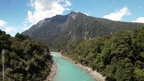 Pristine water of Copland river, native forest and mountain vista. Beautiful day in New Zealand, birds eye view. photo