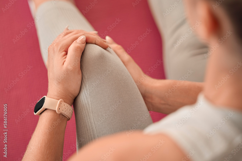 Fototapeta premium Top of woman, knee pain and injury in gym for fitness, first aid emergency and exercise health risk. Closeup legs of female athlete, accident and workout mistake of injured muscle, problem and wound