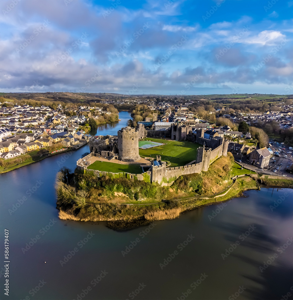 An aerial view above the castle and town of Pembroke, Wales just before sunset