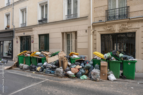 Paris, France - 03 28 2023: Garbage cans left on the public highway, following the garbage collectors' strike.