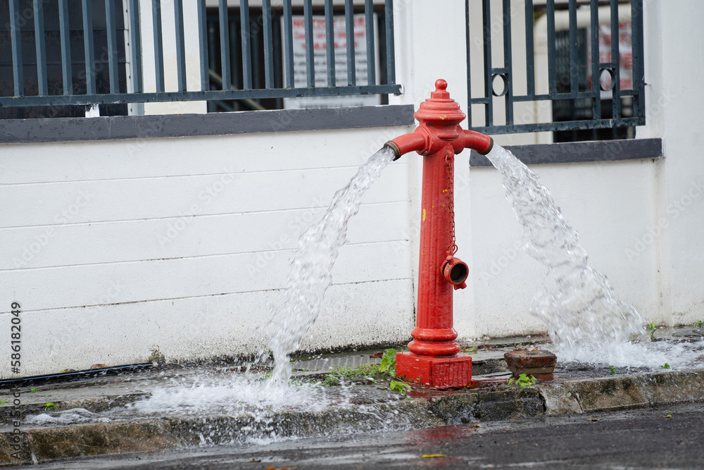Fire hydrant being flushed by for maintenance. Fire hydrant leaking. 素材