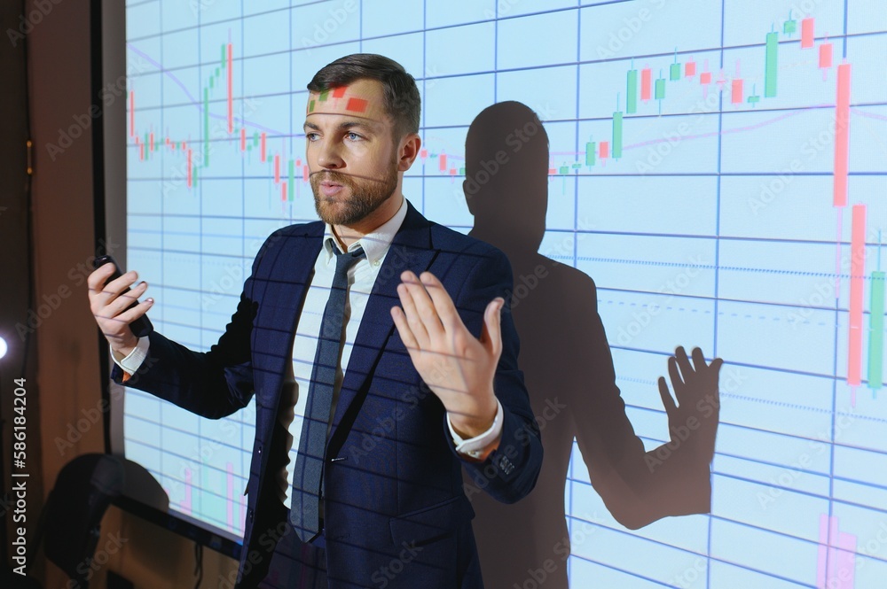 Business Conference Meeting Presentation: Businessman does Financial Analysis talks to Group of Businessspeople. Projector Screen Shows Stock Market Data, Investment Strategy, Revenue Growth Business Conference Meeting Presentation: Businessman does Financial Analysis talks to Group of Businessspeople. Projector Screen Shows Stock Market Data, Investment Strategy, Revenue Growth