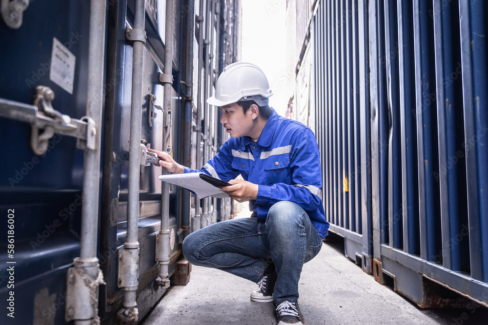 Asian male foreman control or check inventory details of containers box, worker checking quantity of product in containers. Asian male foreman control or check inventory details of containers box, worker checking quantity of product in containers.