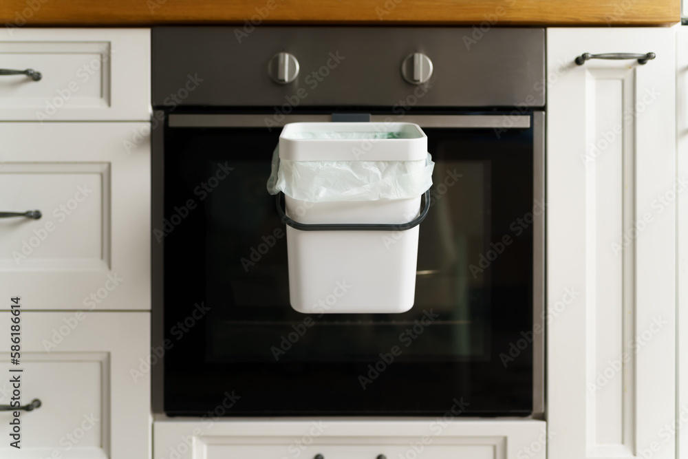 Fototapeta premium Compost bin in a domestic kitchen. Bokashi container for biodegradable food leftovers. Recycle organic waste into natural fertilizer