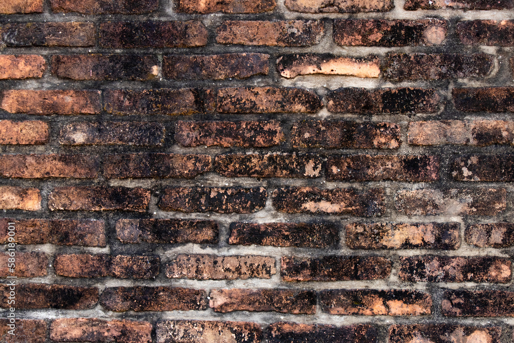 Grunge old and crack red color brick with black stain wall textured background. Grunge old and crack red color brick with black stain wall textured background.