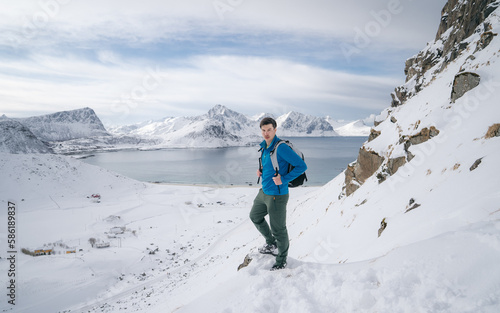 A traveler braving the winter elements on Lofoten Islands. Press on towards their goal. Enhance the sense of isolation and danger. Winter exploration in the beautiful yet unforgiving landscapes. 