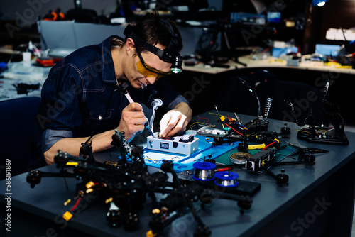 Fotografie Engineer working on racing fpv drone combat kamikaze bomber in workshop