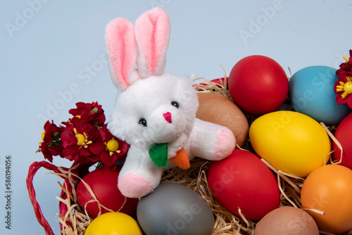 basket with straw and eggs decorated for the celebration of Christian Easter