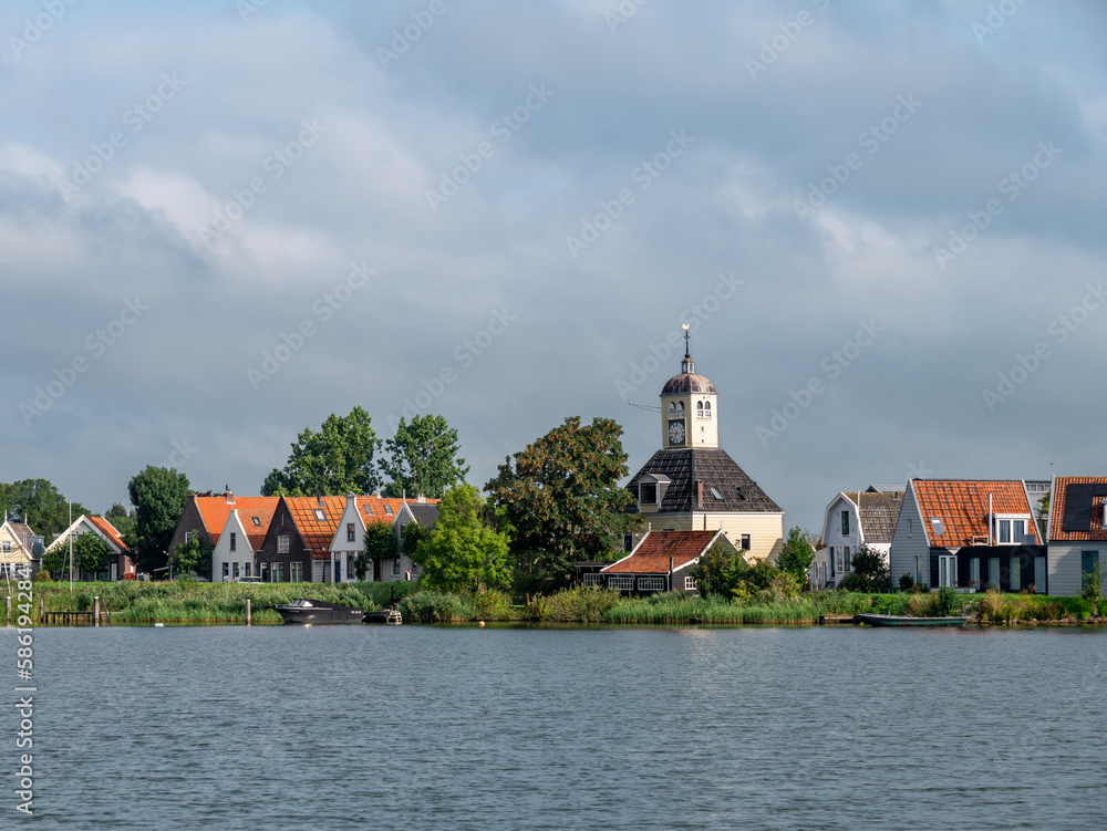 Church and houses of Durgerdam village from Buiten IJ river near Amsterdam, Netherlands